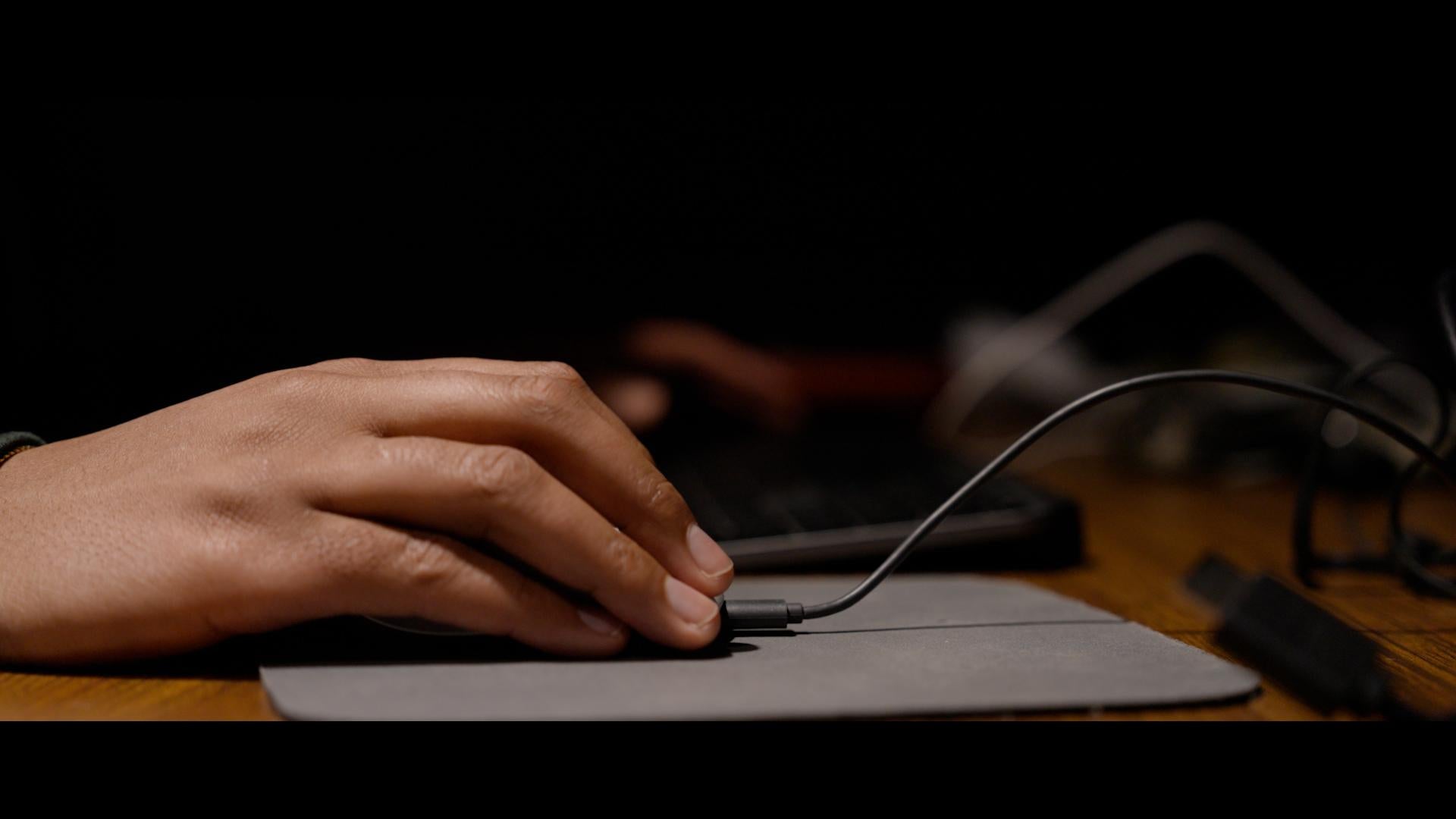 Zion Atwater (filmmaker) holding computer mouse for editing