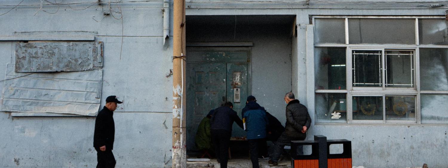 Photographic art of men by door of abandoned stores