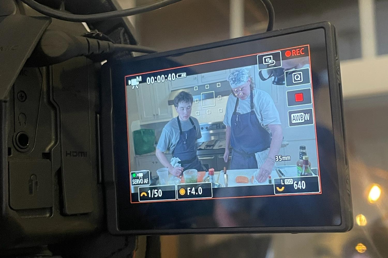 Camera monitor view of chefs Will and Ben