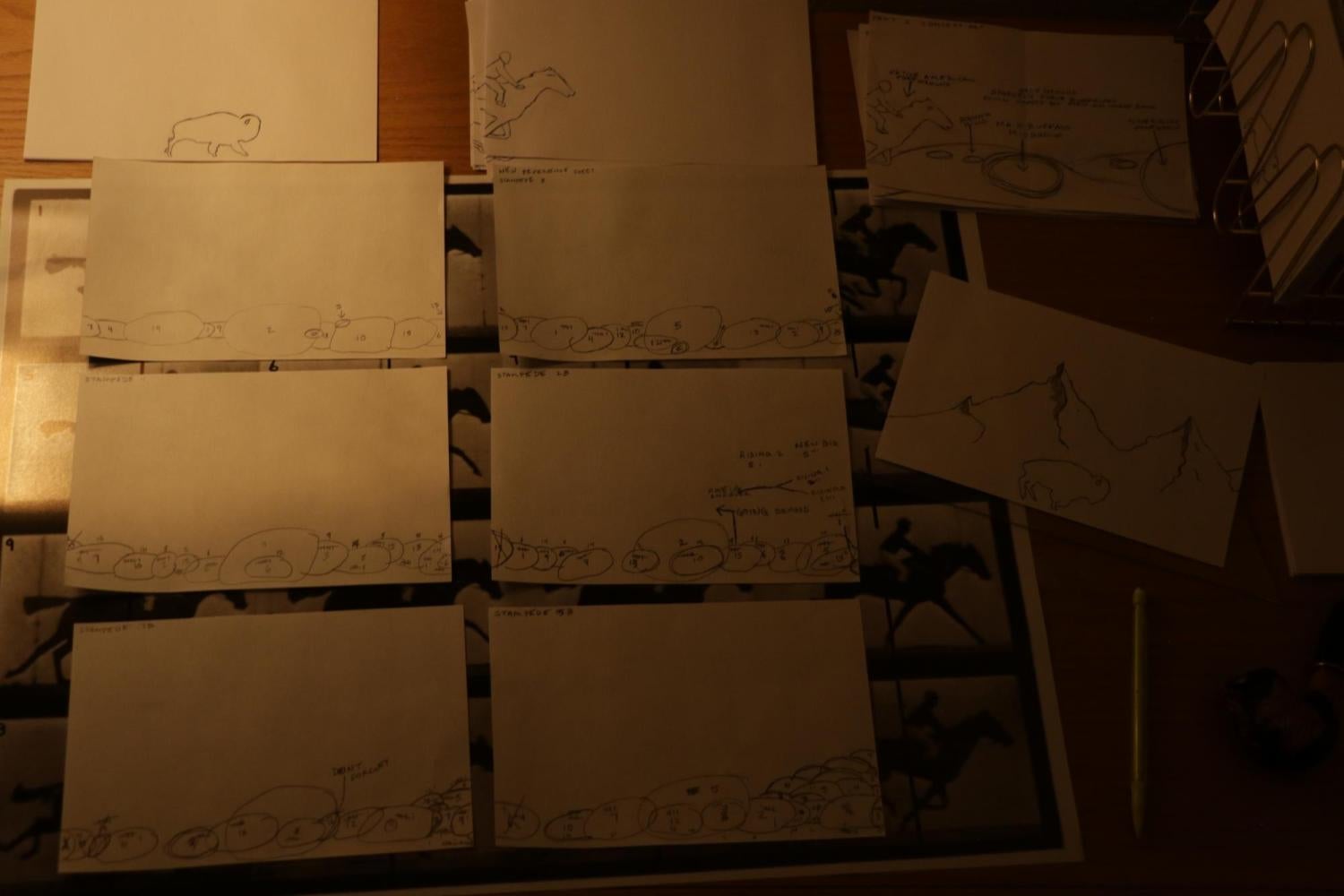 Collection of hand drawn stencils and concept art on a table