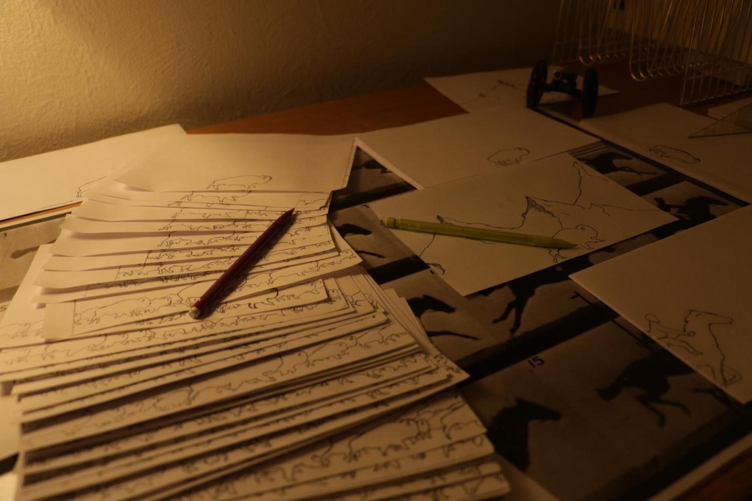 Collection of hand drawn stencils and concept art on a table