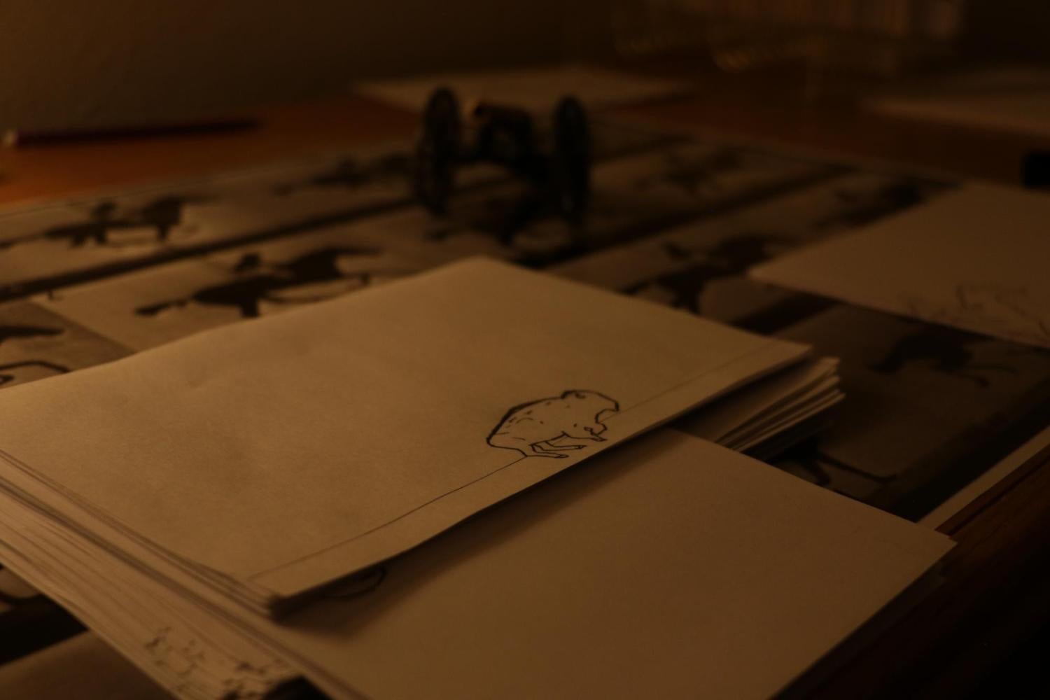 Collection of hand drawn stencils and concept art on a table