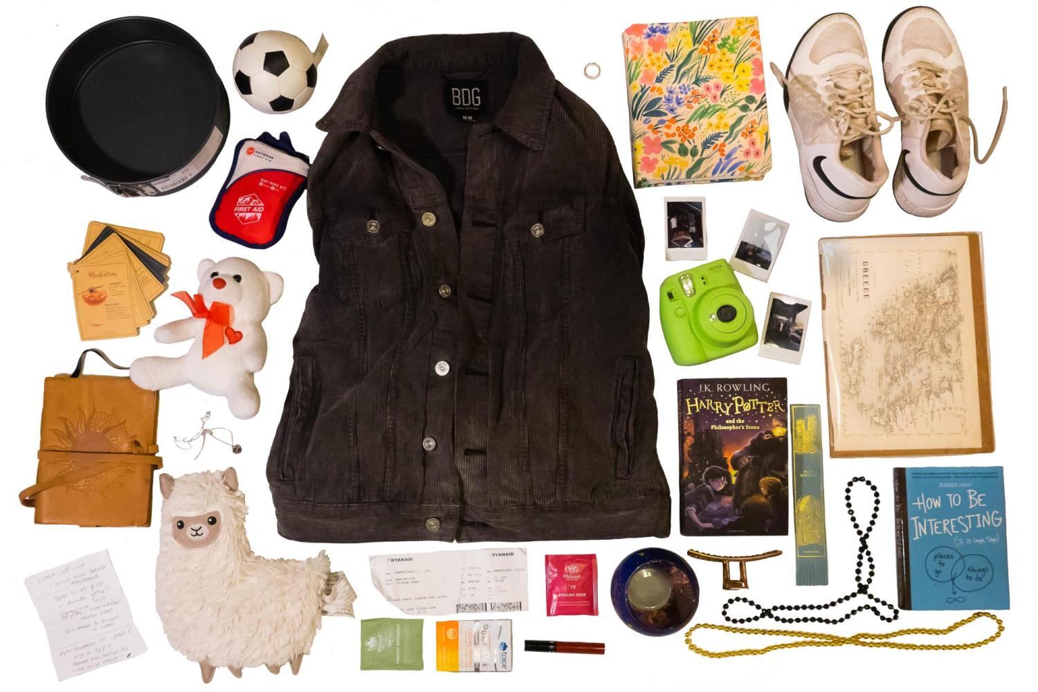 A flat-lay style collage featuring a collection of material objects belonging to Jess.