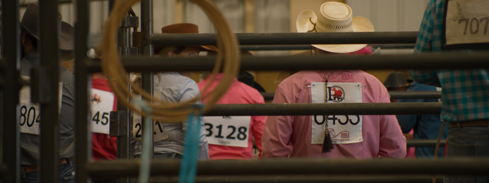 Cowboys and cowgirls prepare for competition behind the chutes
