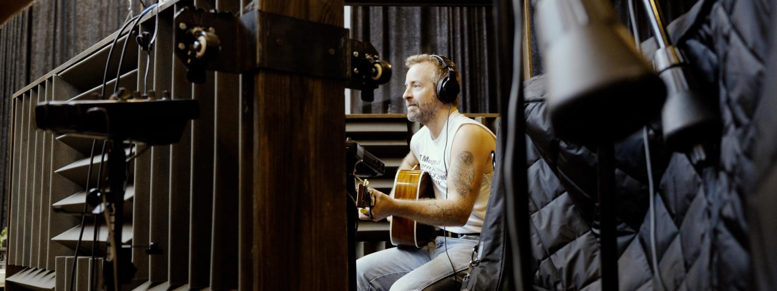 Dave Simonett playing guitar during recording