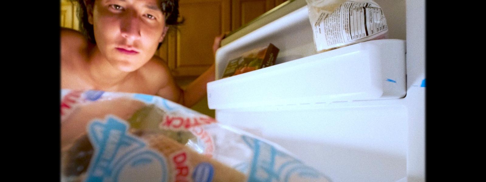 person looking in a fridge