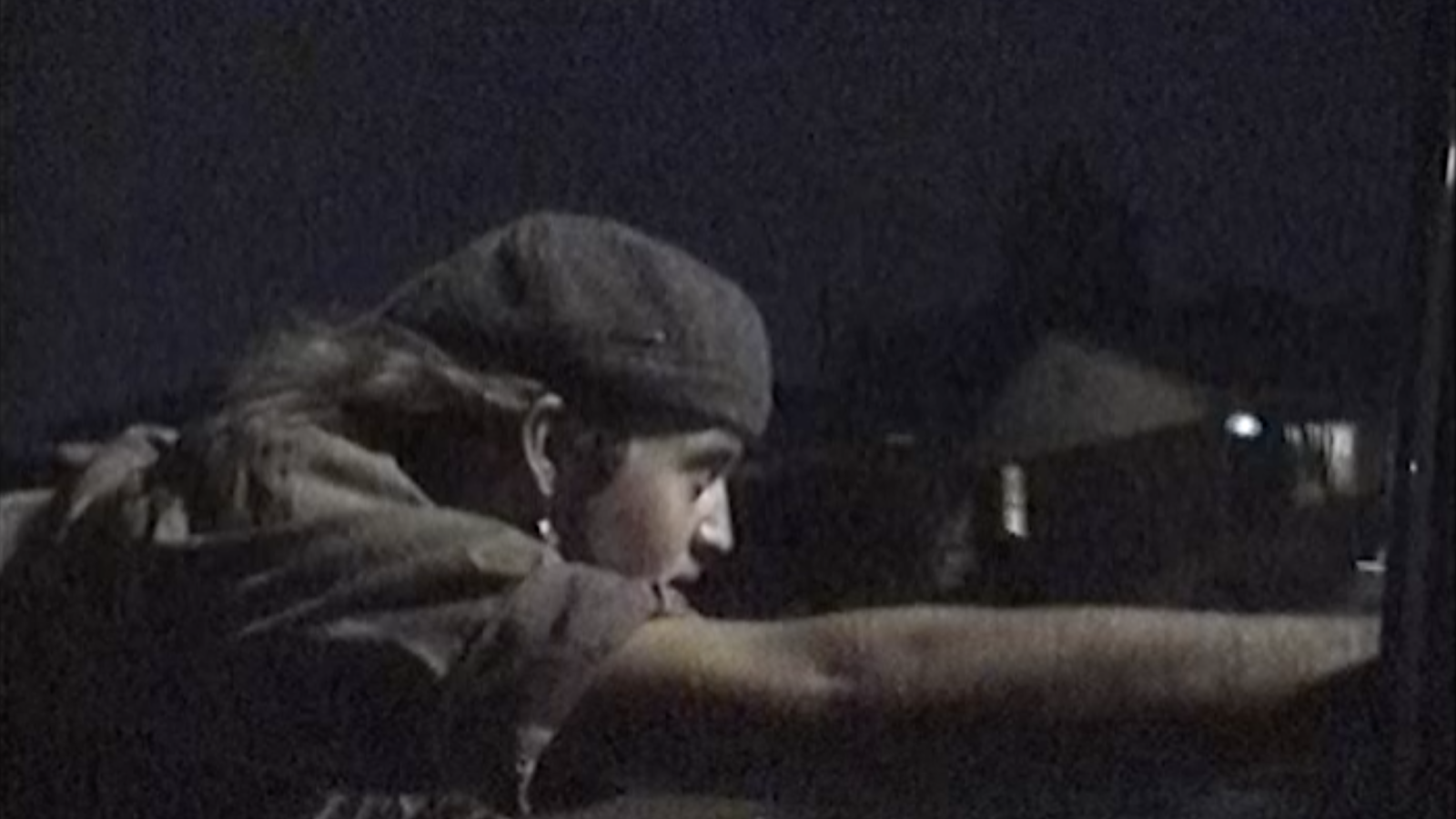 Jack riding skateboard, holding onto the car, from the perspective of inside the car.