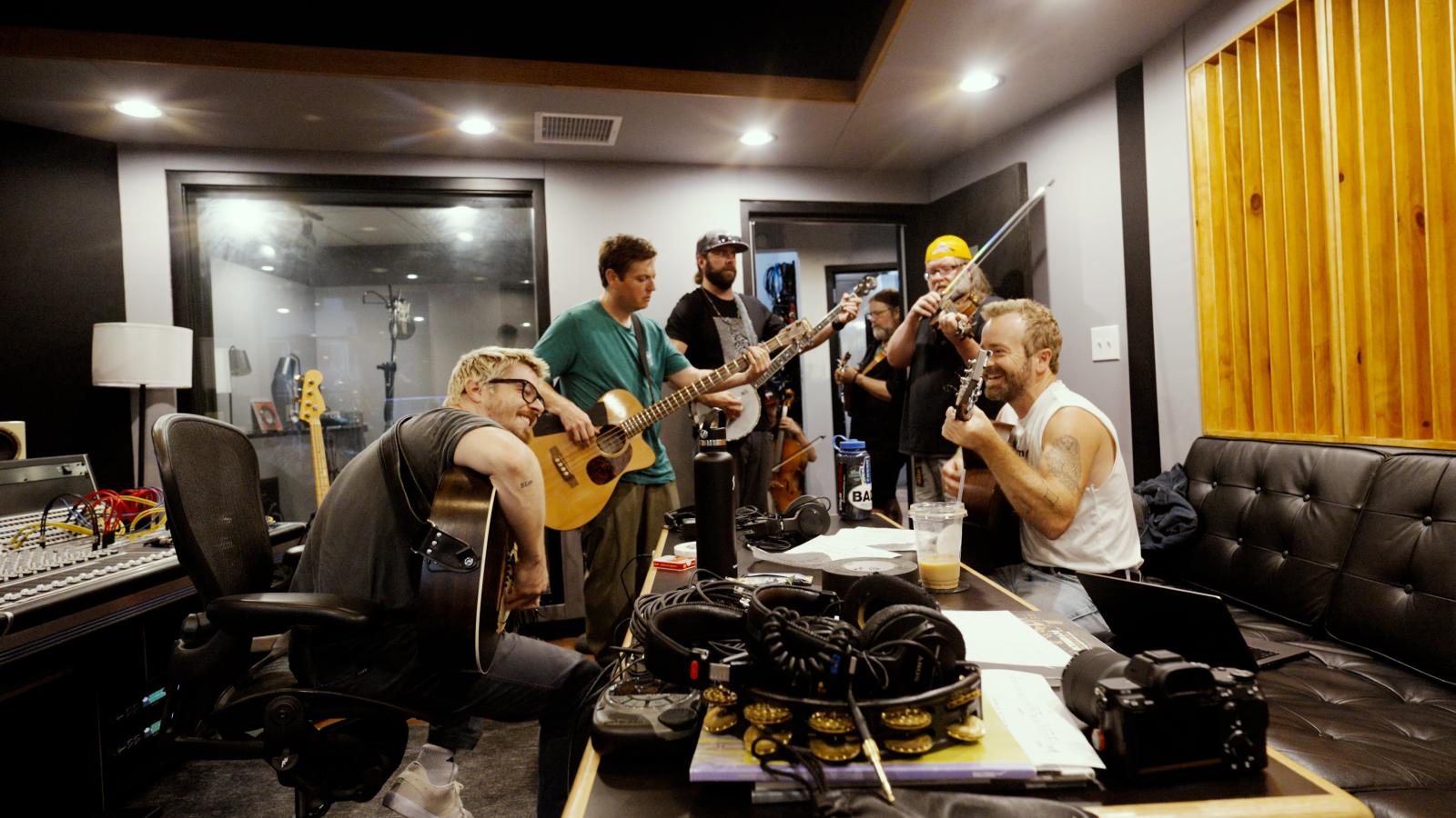 Josiah and Trampled by Turtles figuring out their version of Rocky Mountain High in the studio board room