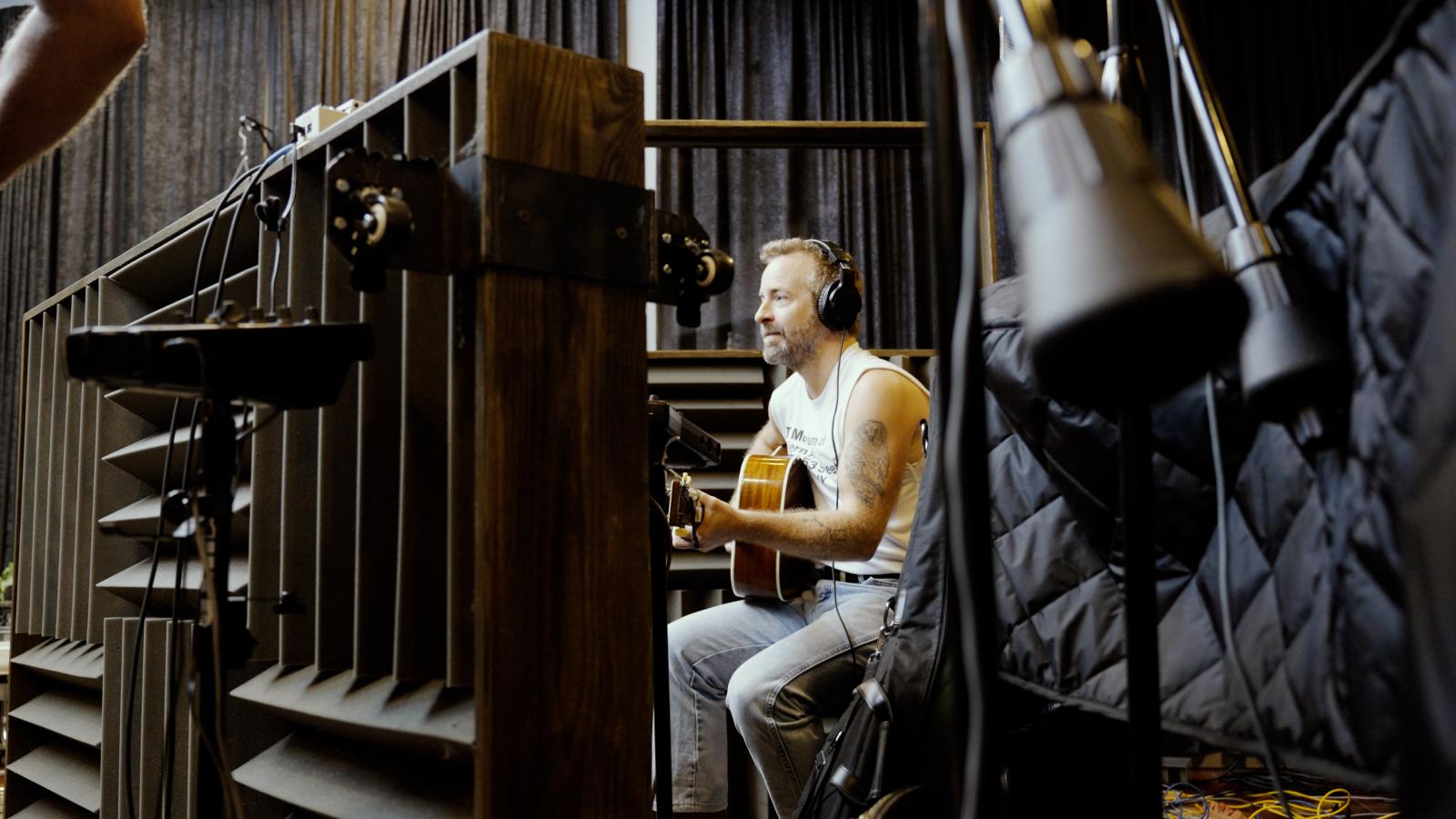 Dave Simonett playing guitar during recording