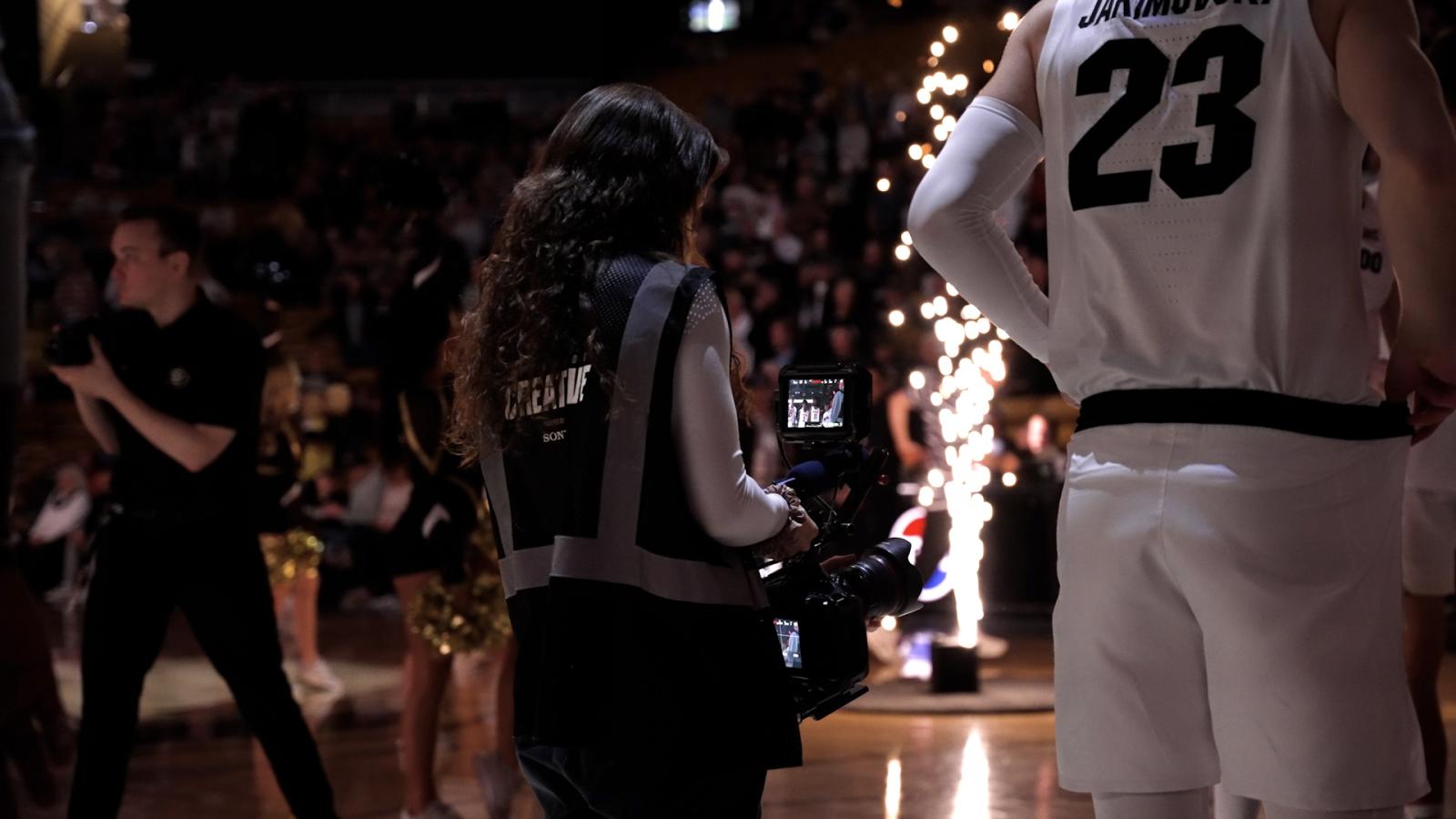 Cameraperson at a basketball game