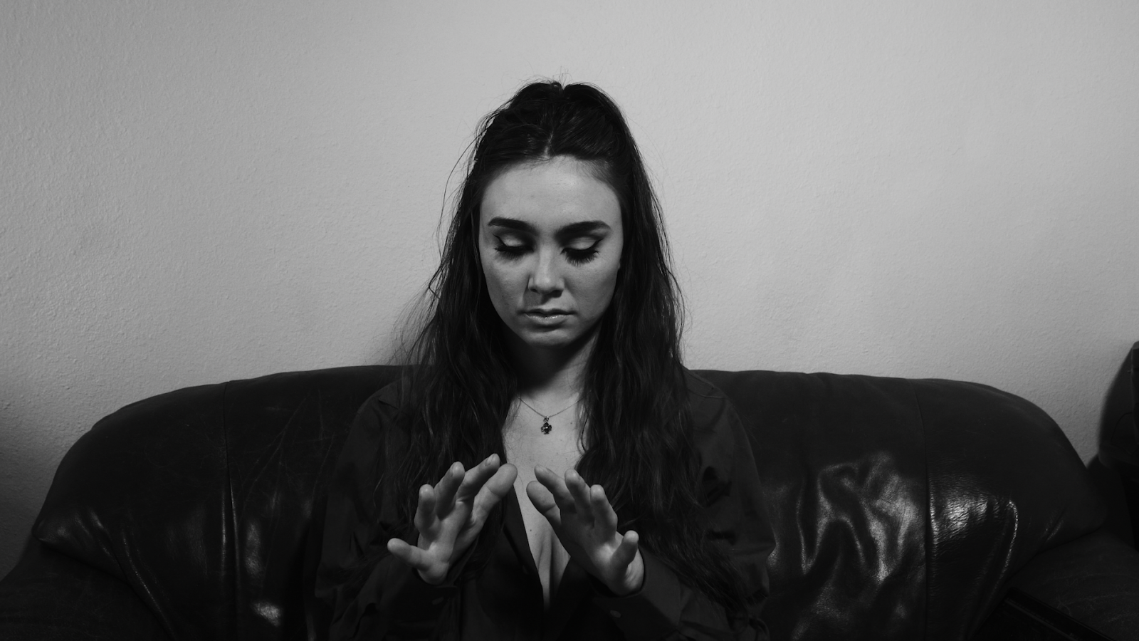 person on a sofa looking at their hands
