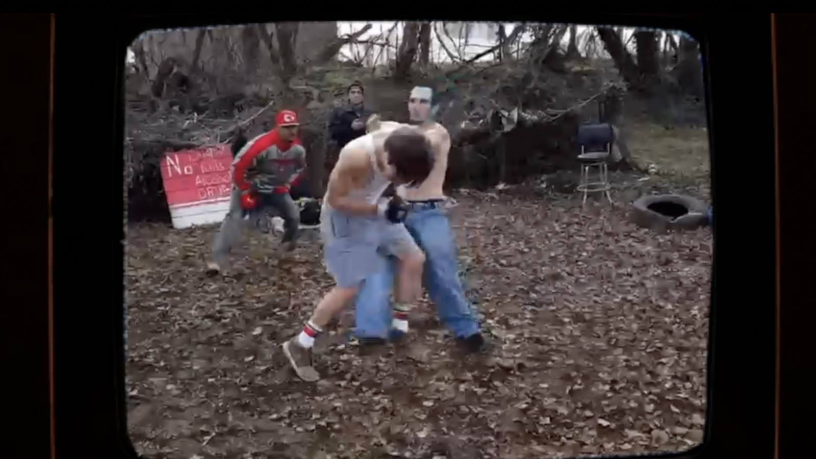 Two men are fighting, one has blue hair and it is this blue haired man who is about to be knocked out.