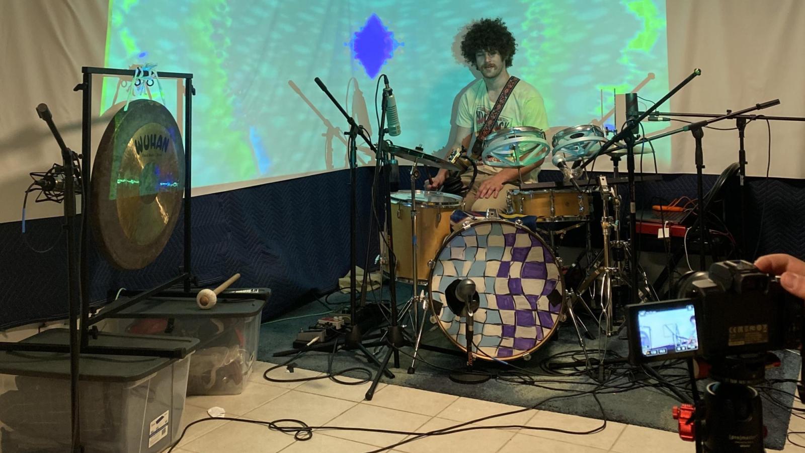 Person filming a drummer