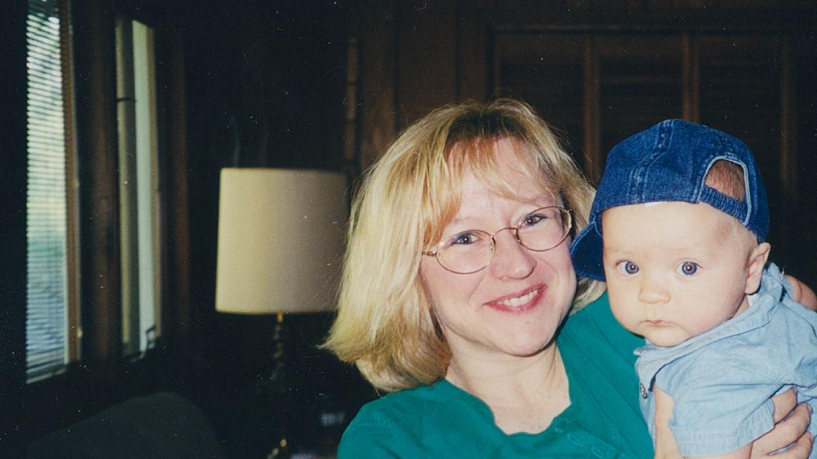 Collin's Mom holding Collin as a baby in the early 2000s