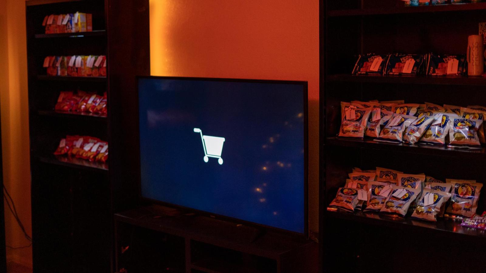 Screen display and bookshelves stacked with food