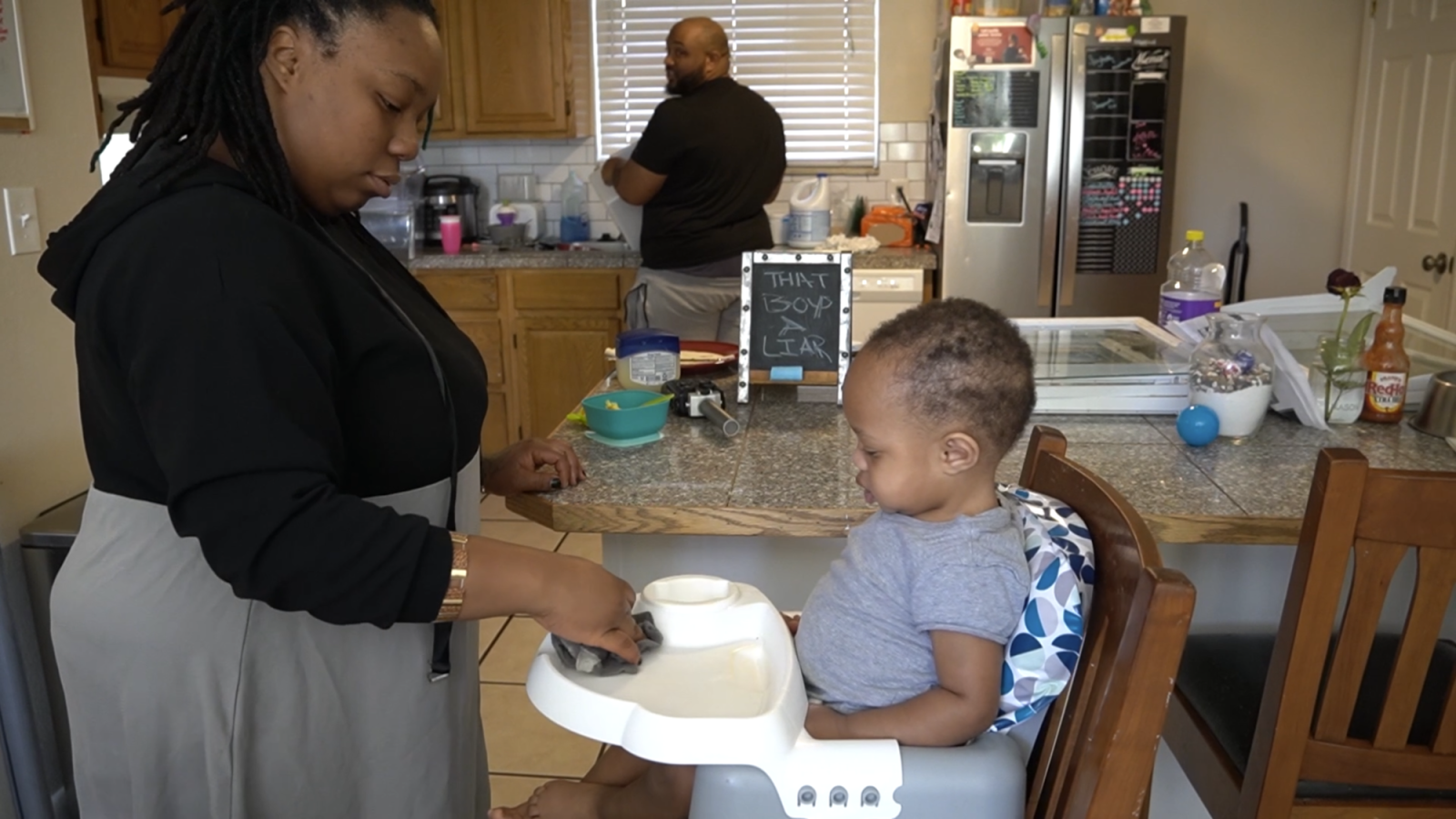  Magan in forefront feeding Sincere, Aaron in background cleaning 