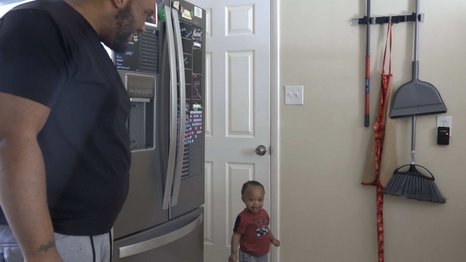 Aaron playing with Sincere in the kitchen