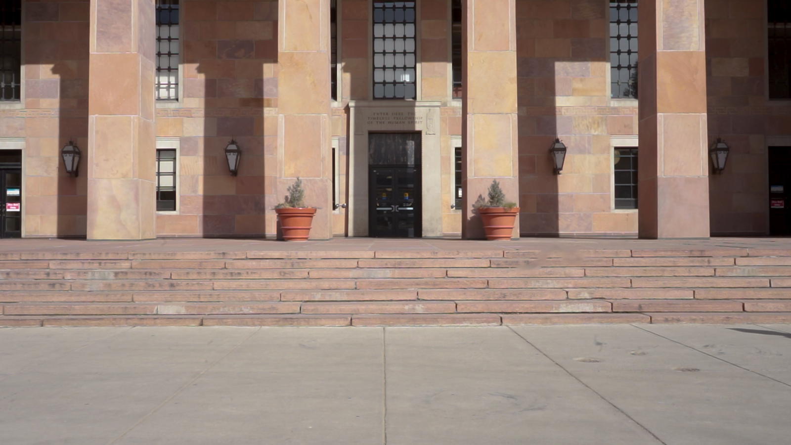 The outside of a large campus library building without anybody in sight.