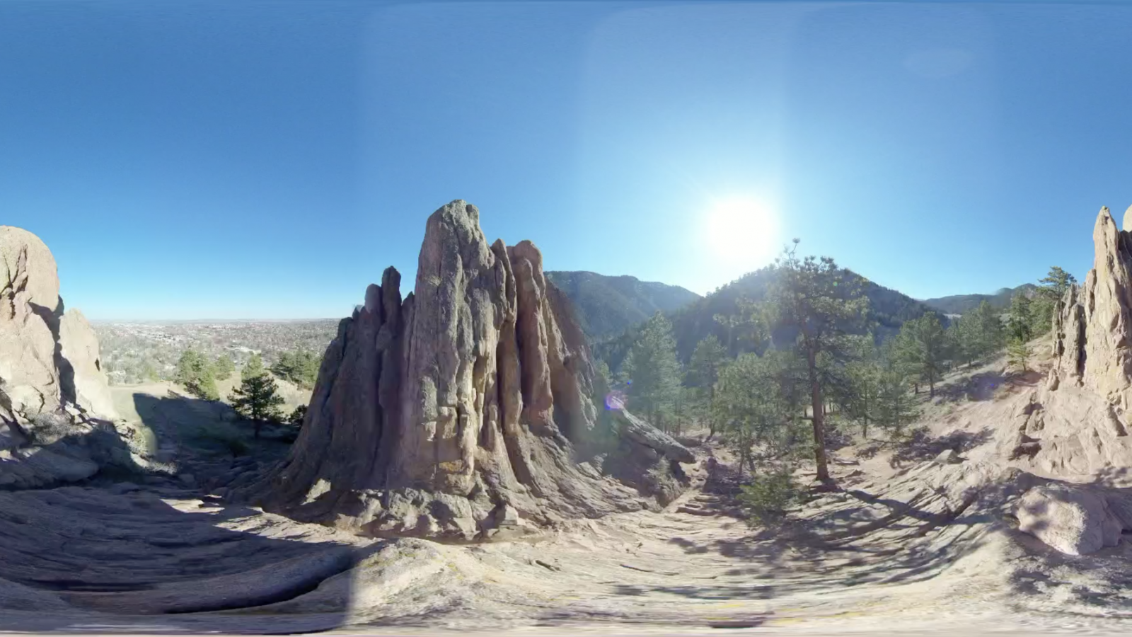 Red rocks landscape with blue sky and bright sun