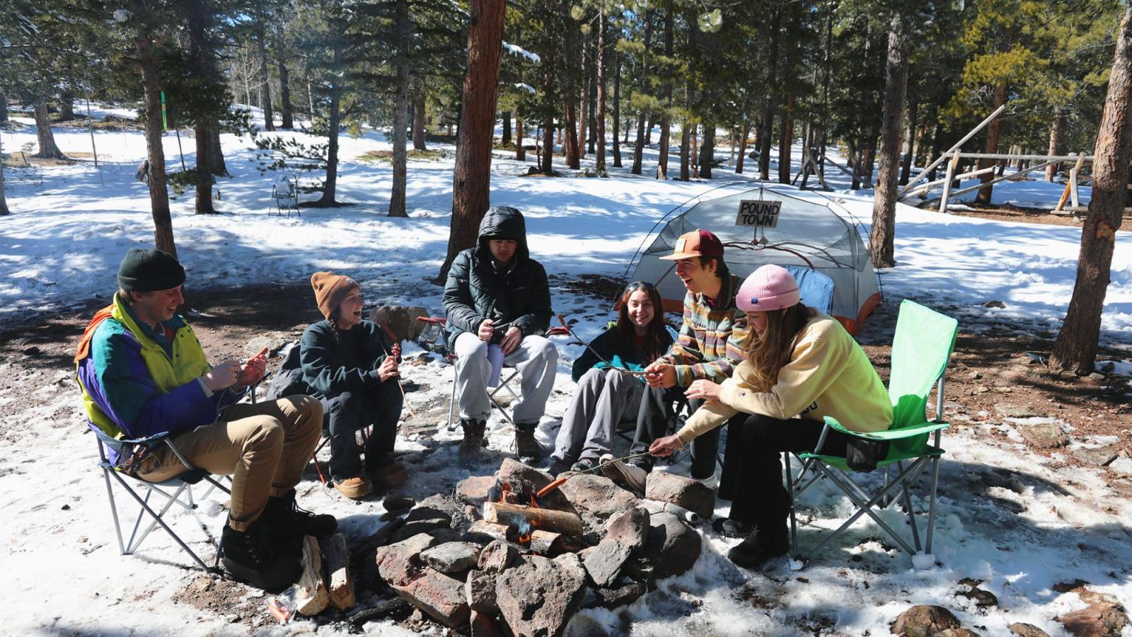 Roastinghotdogs- This is a photo of the whole cast roasting hot dogs around the fire.