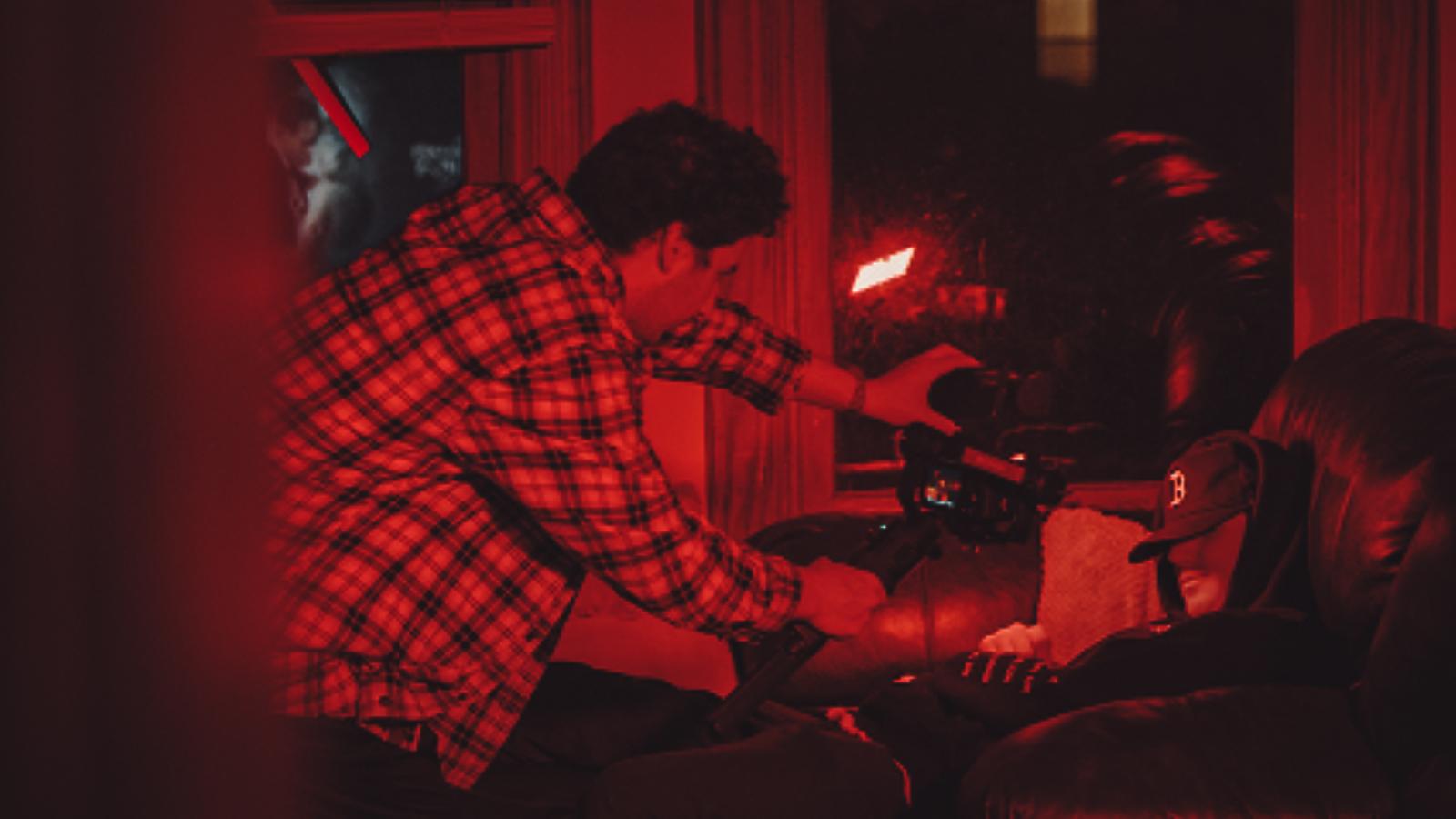 film crew inside a red living room
