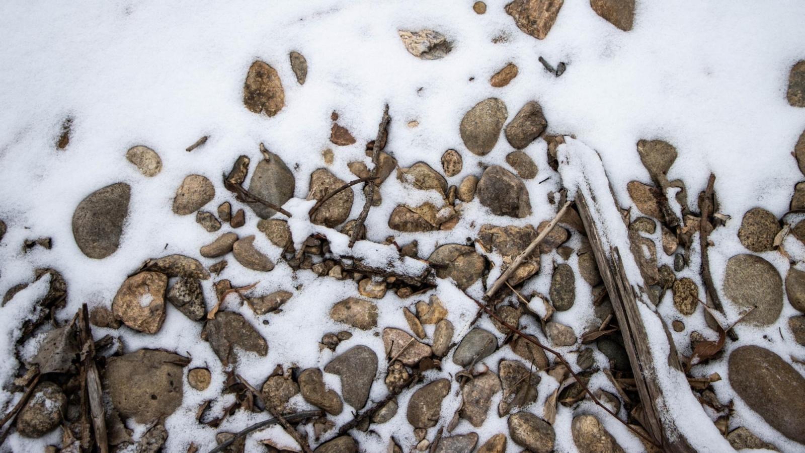 Rocks in a creek with snow