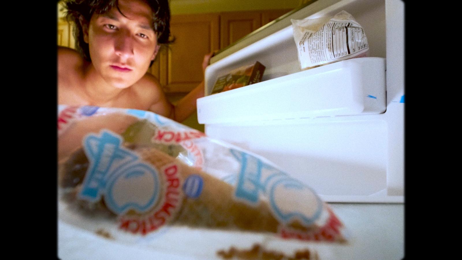 Close up of person getting food from a fridge