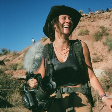 Woman in the desert making a documentary