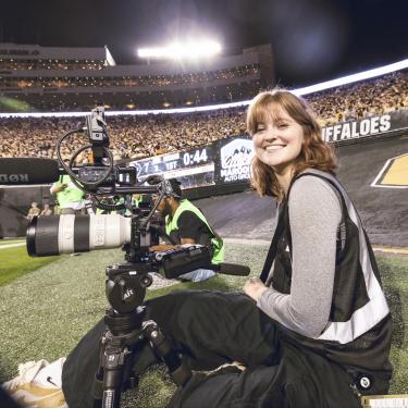 Ally Standing in a Stadium