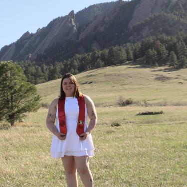 Woman in a white dress in front of mountains