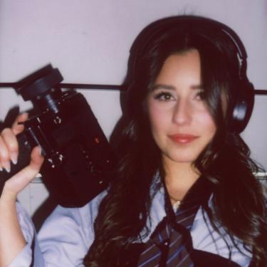 Vera holding camera