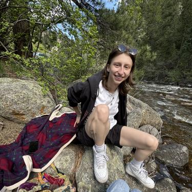 Rae Sitting in Front of Stream