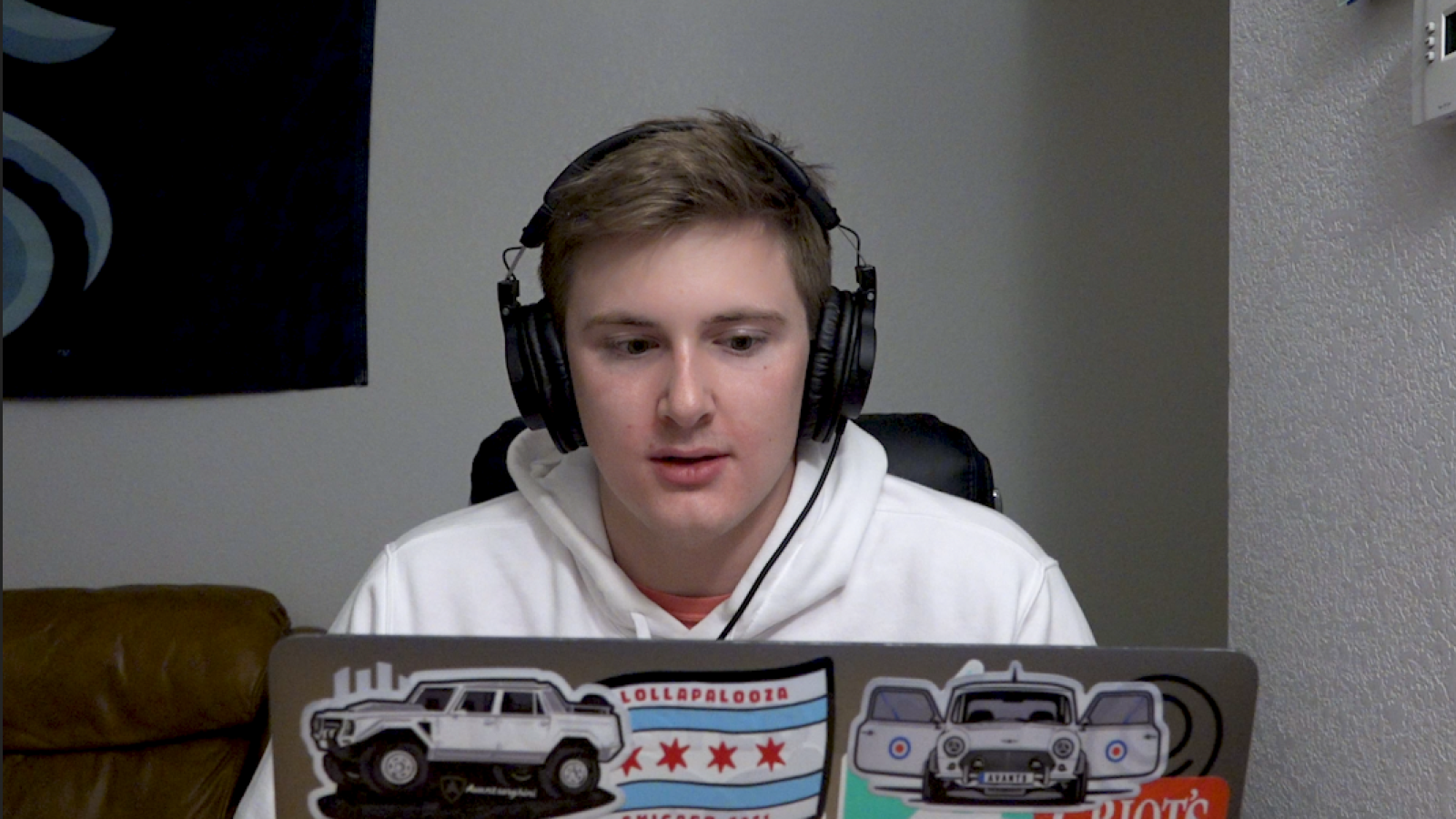 A full frame reaction image of Austin looking at his computer. He appears surprised.