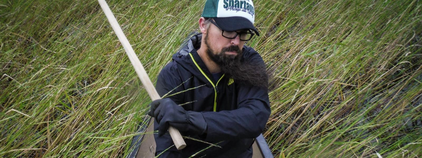 Scientist Kyle Whyte shown harvesting rice