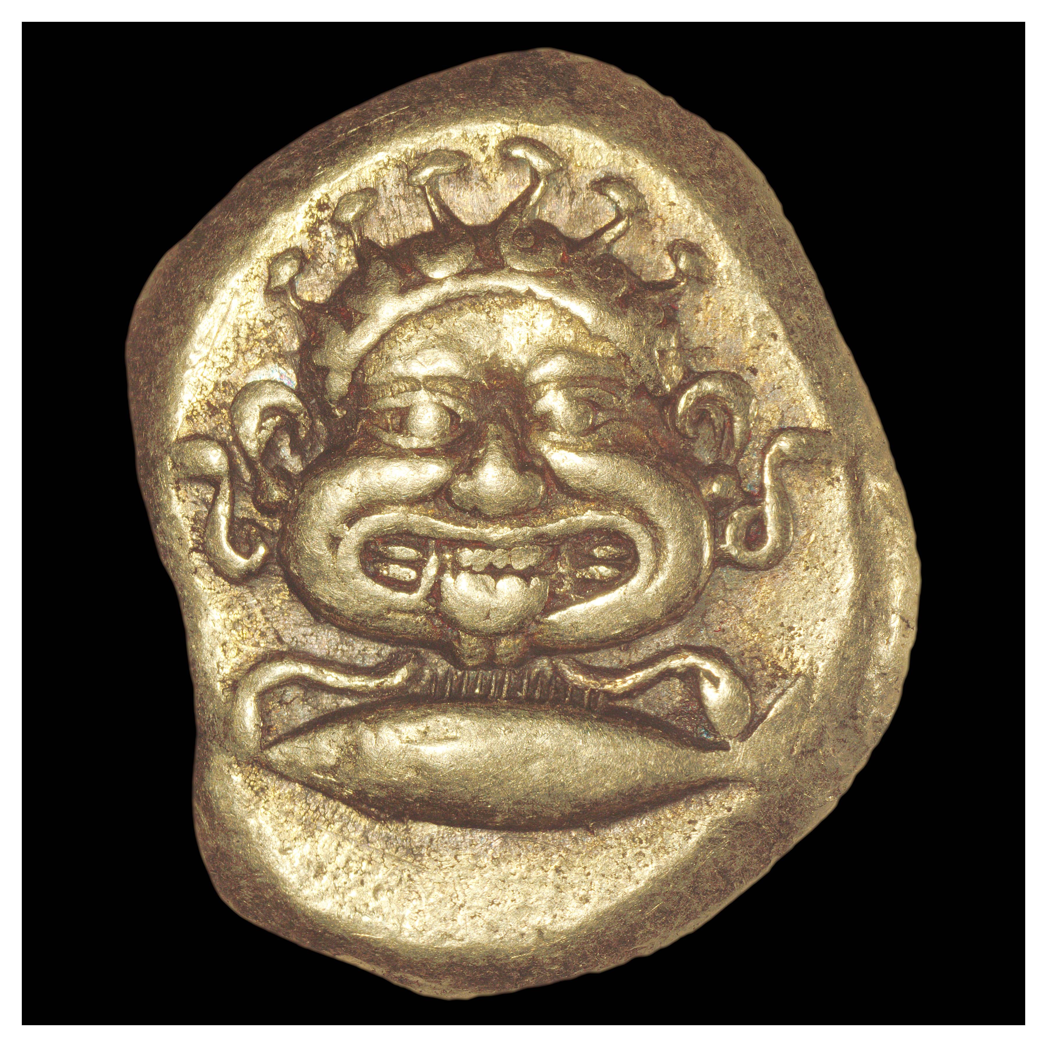Electrum Stater, Cyzicus, 500-450 BCE; Obverse: Gorgon head with snakes over tuna fish.