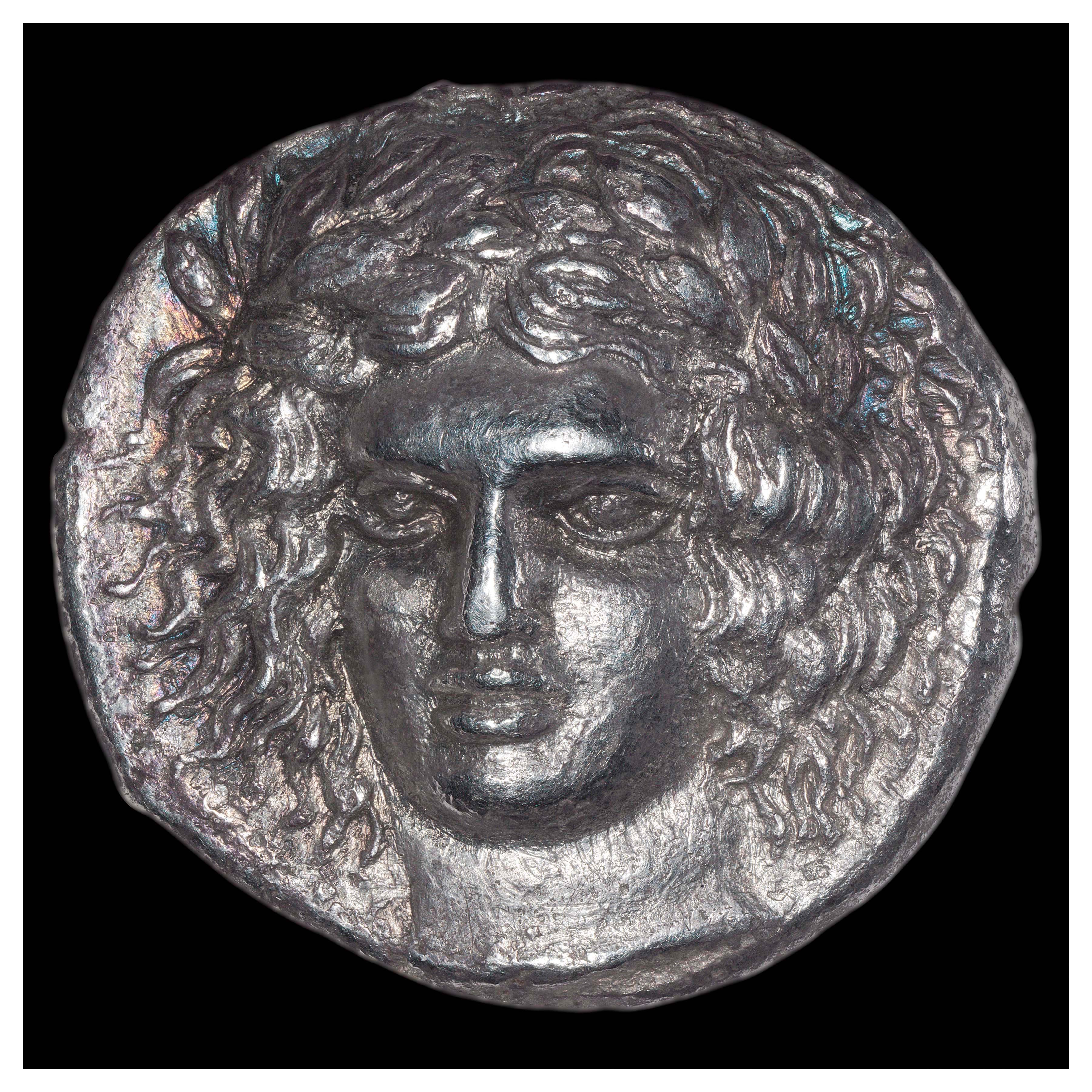 Silver Tetradrachm, Catane, 405-403/2 BCE; Obverse: Head of Apollo. Inscription ΗΡΑKΛΕΙΔΑΣ (HERAKLEIDAS = artist’s signature).