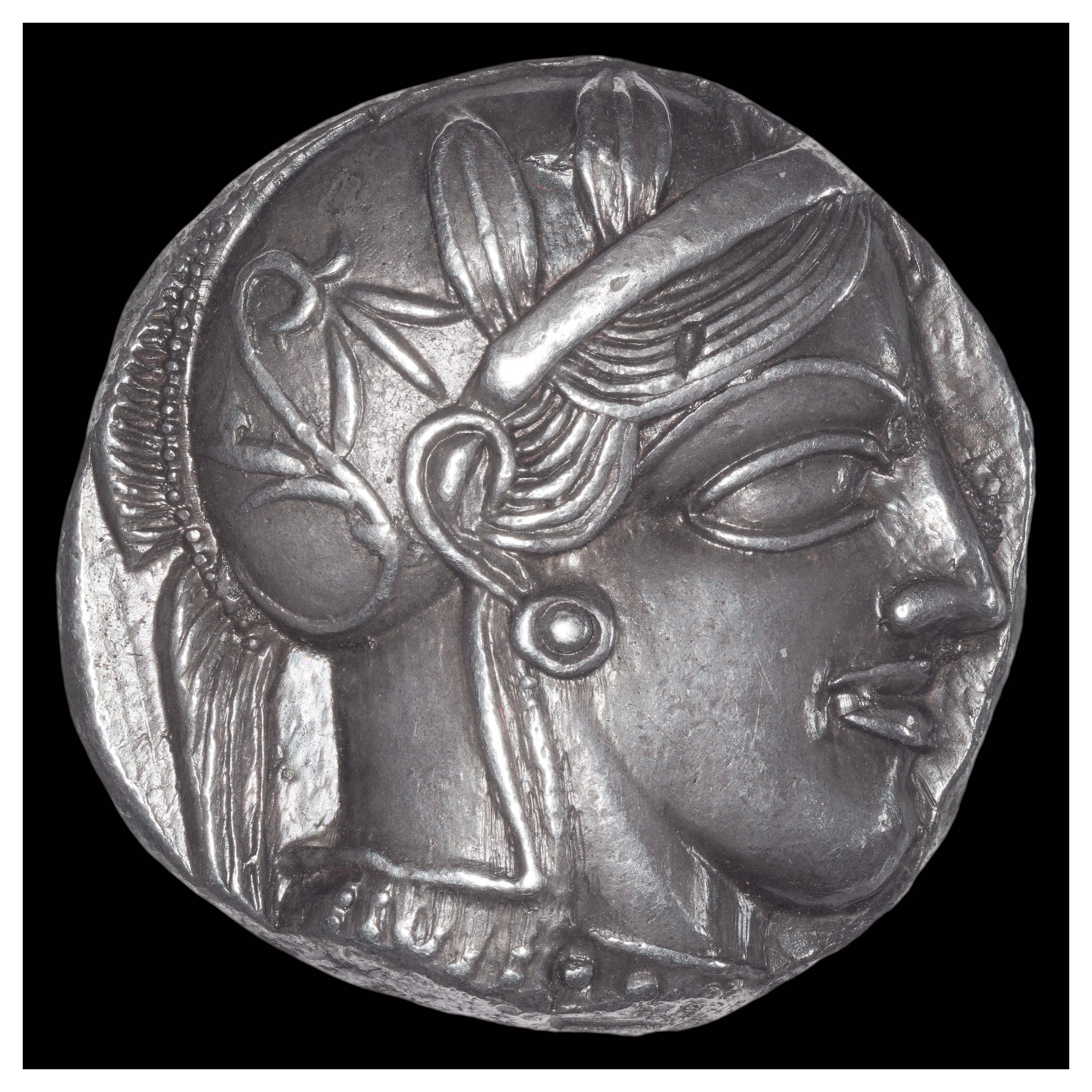 Silver Tetradrachm, Athens, 449-404 BCE; Obverse: Helmeted head of Athena with olive leaves and floral scroll.