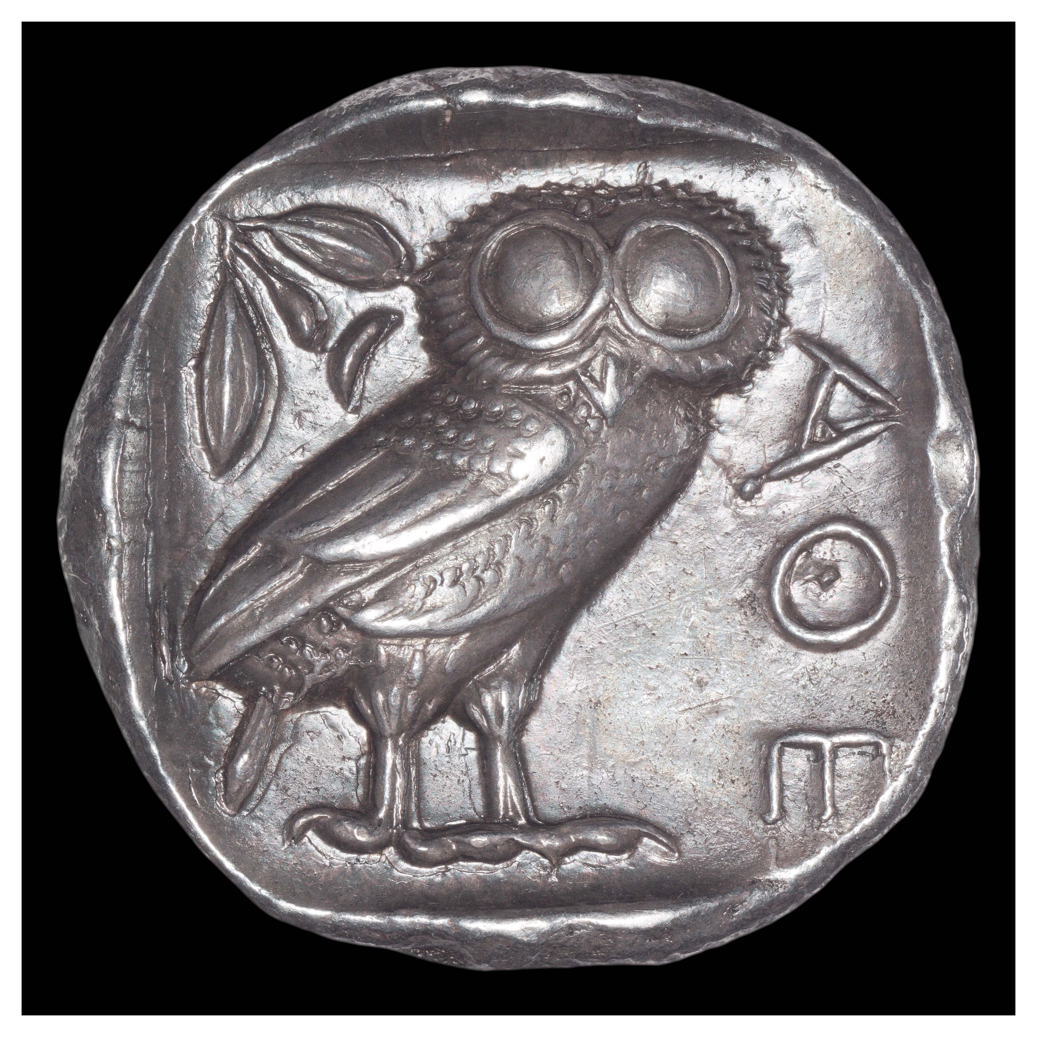 Silver Tetradrachm, Athens, 449-404 BCE; Reverse: Owl with olive spray and small crescent. Inscription ΑΘΕ (ATHE = abbreviation for “of the Athenians”).