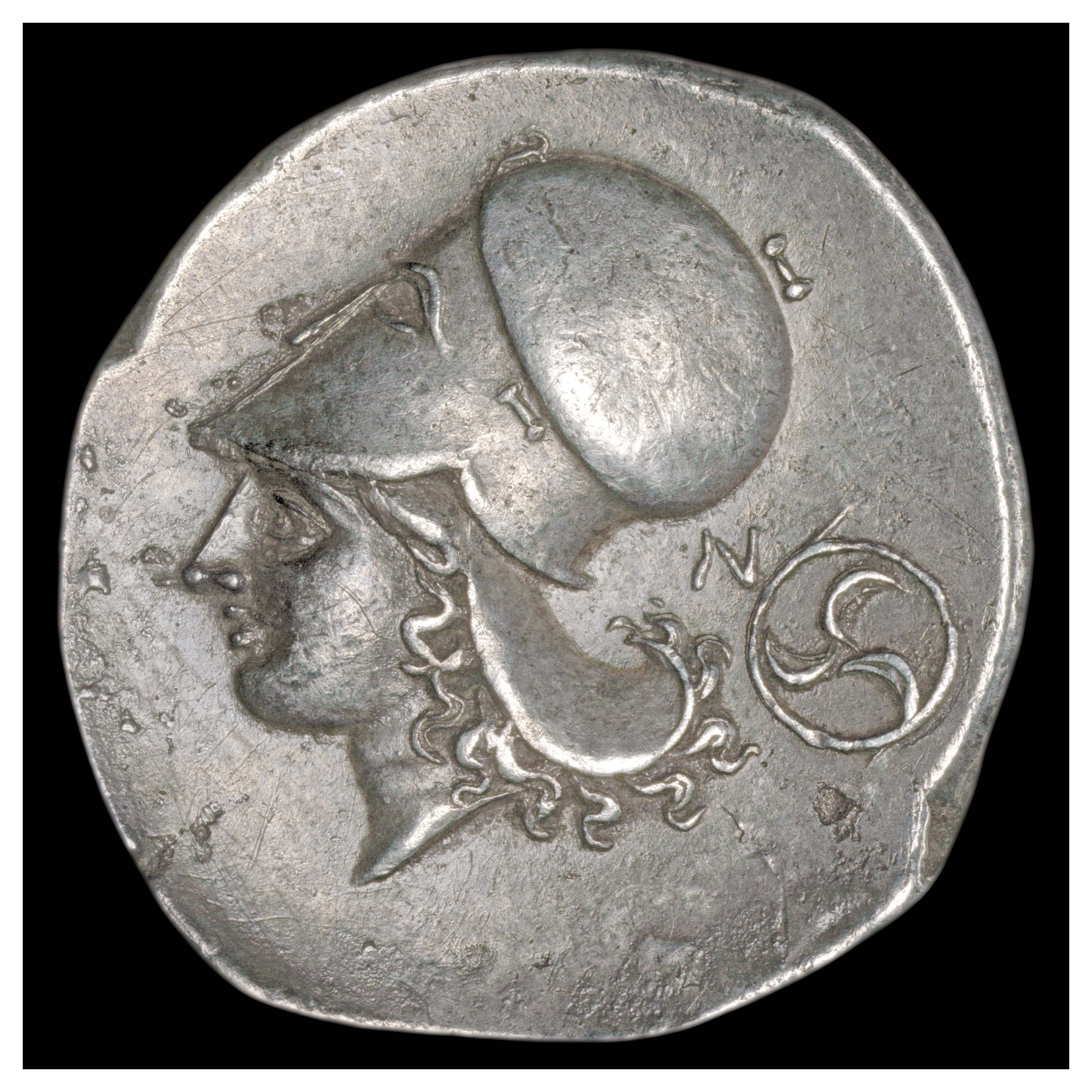 Silver Stater, Corinth, 350-338 BCE; Reverse: Helmeted head of Athena. ‘N’ and triskelon symbol on the right.