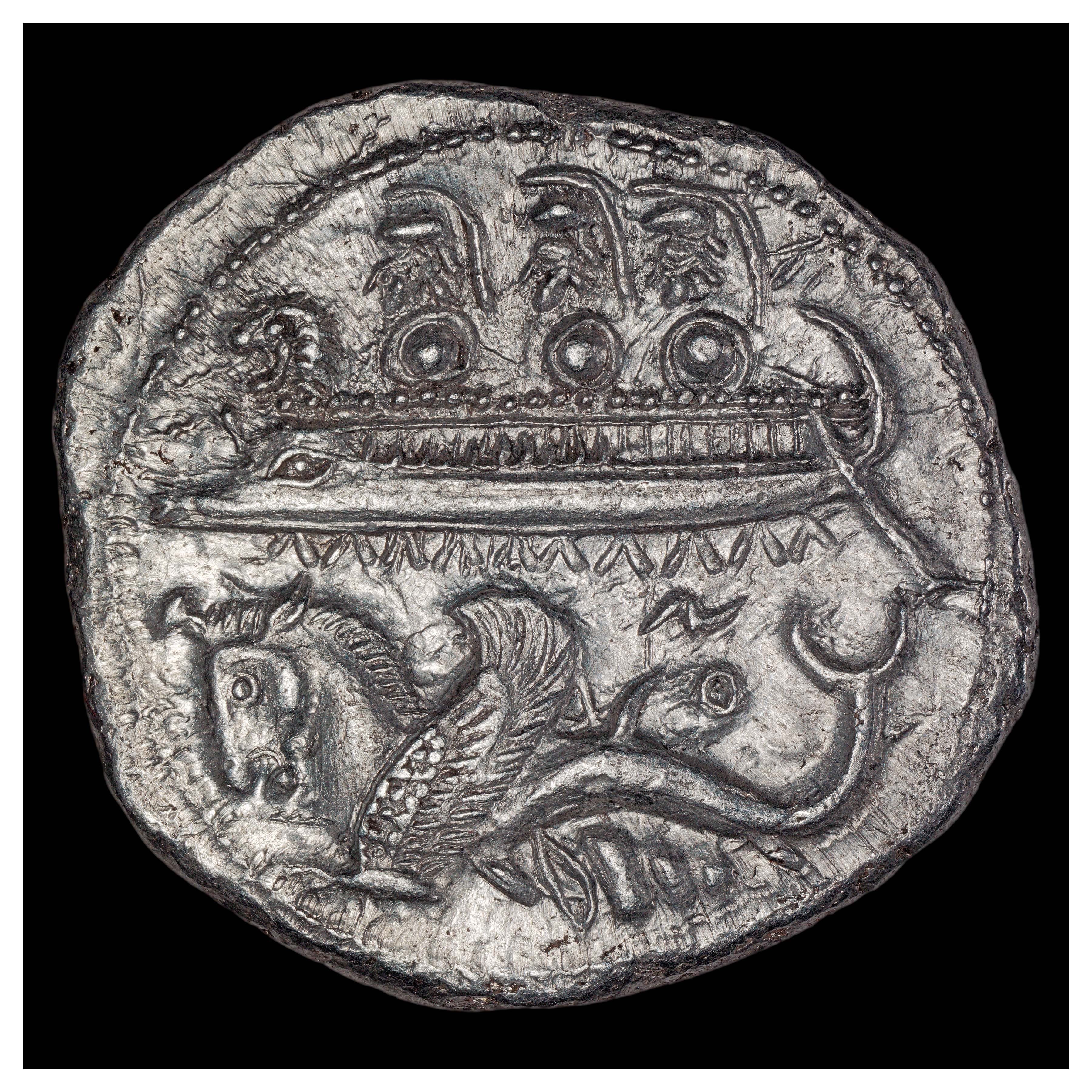 Silver Shekel, Byblos, 365-360 BCE; Obverse: Warriors in battleship with lion head, winged hippocamp, murex shell. Inscription ZO (meaning uncertain).