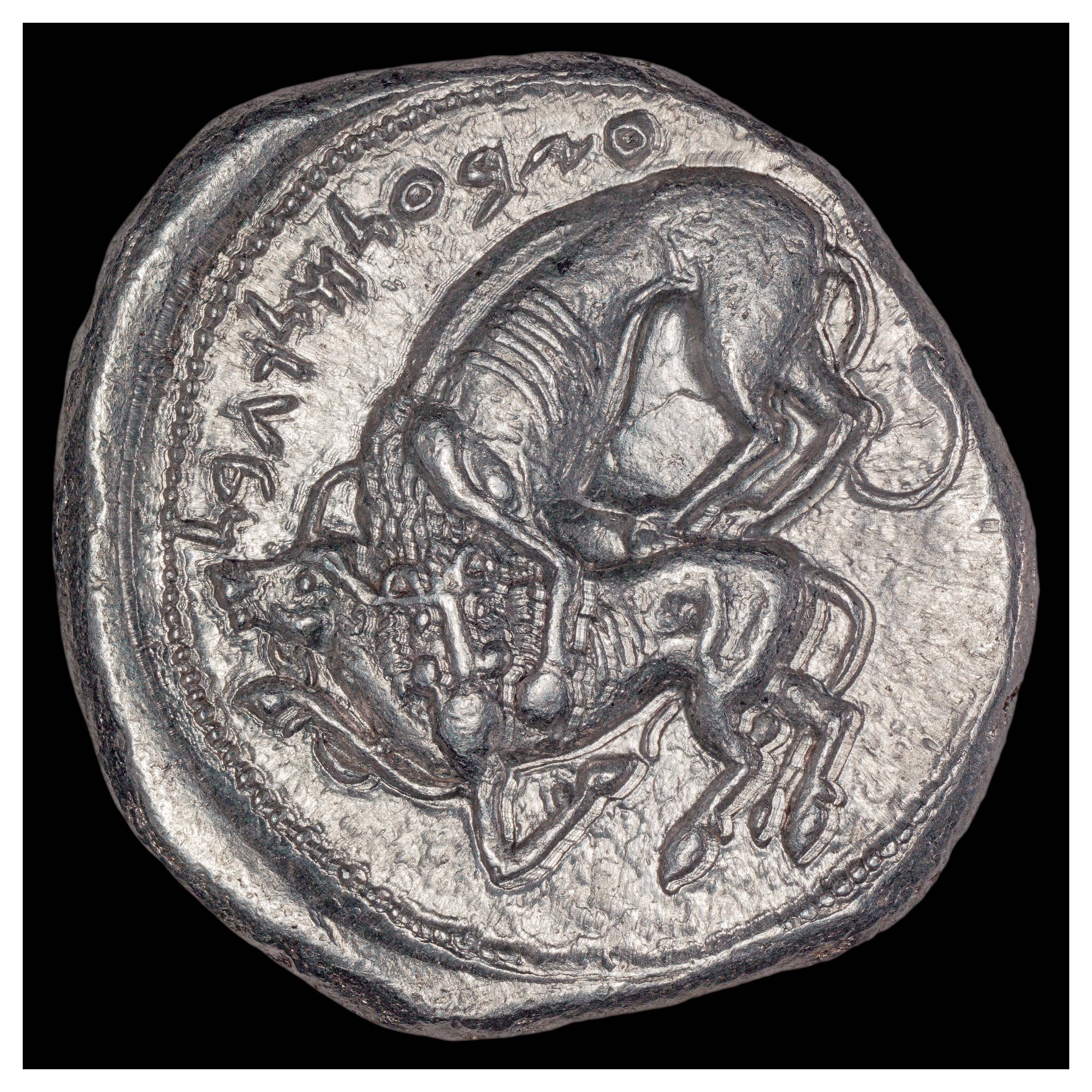 Silver Shekel, Byblos, 365-360 BCE; Reverse: Lion attacking bull. Inscription ZB’L MLK GBL (“Ozbal king of Gebel” in Aramaic).
