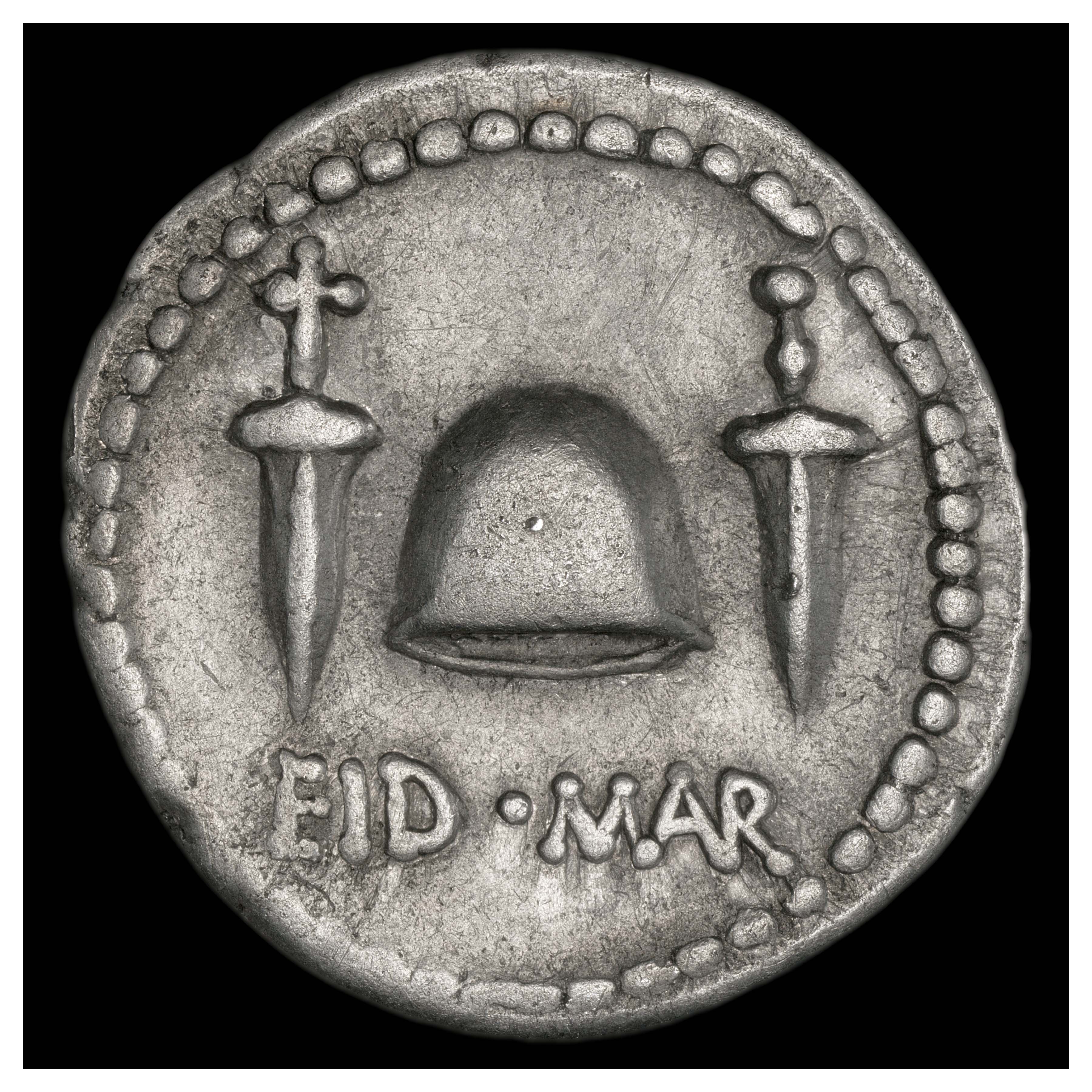 Reverse: Pileus between two daggers. Inscription EID(ibus) MAR(tiis) (= “The Ides of March”).