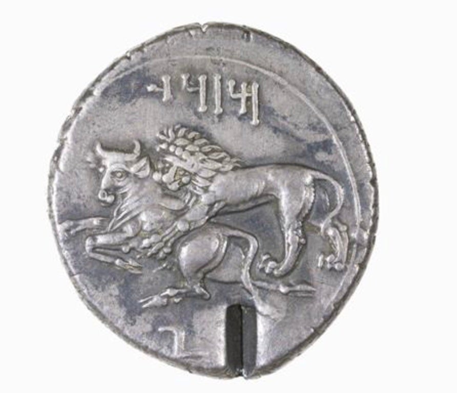 Silver Stater, Tarsus, 363-334 BCE; Reverse: Lion attacking bull. Inscription MZDI (“Mazdaios” in Aramaic).
