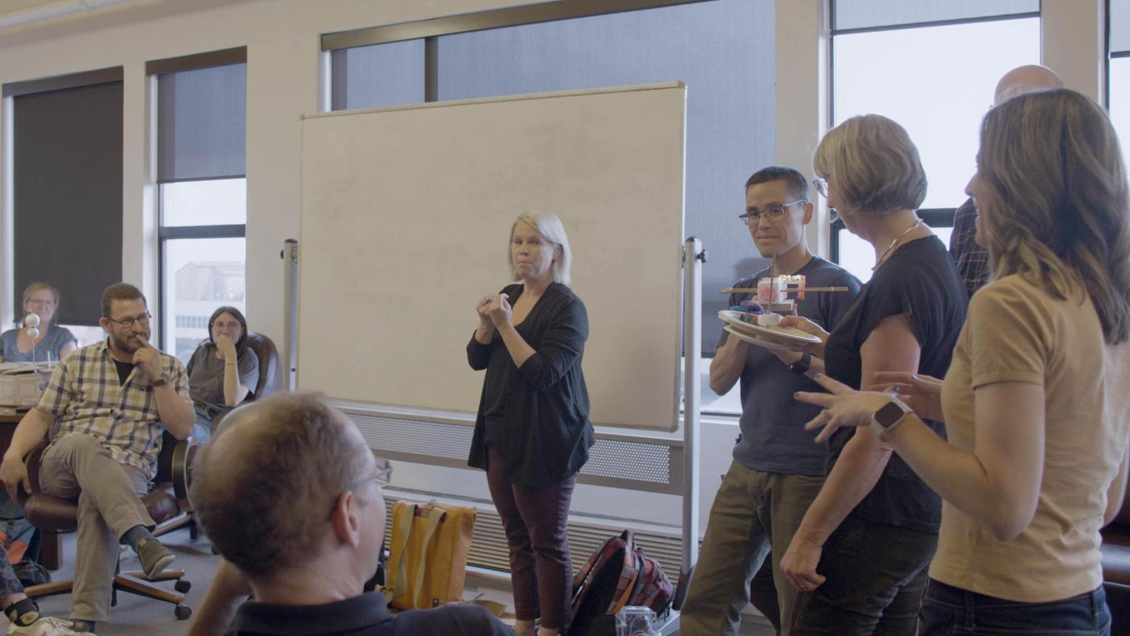 Group of people holding their design