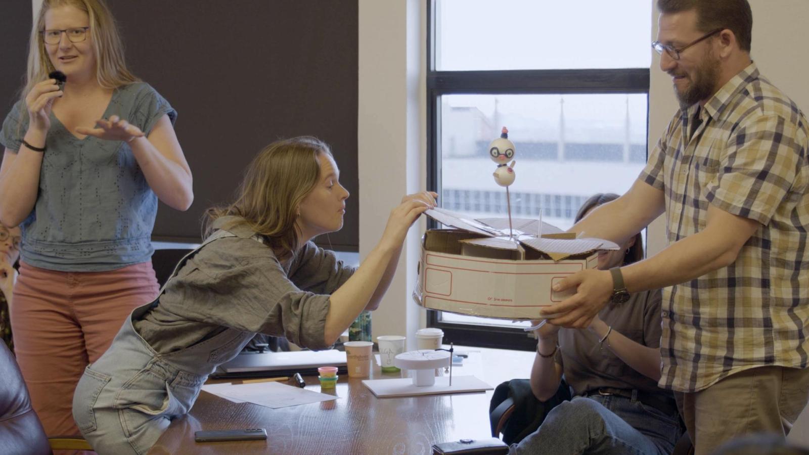 Three people present their design