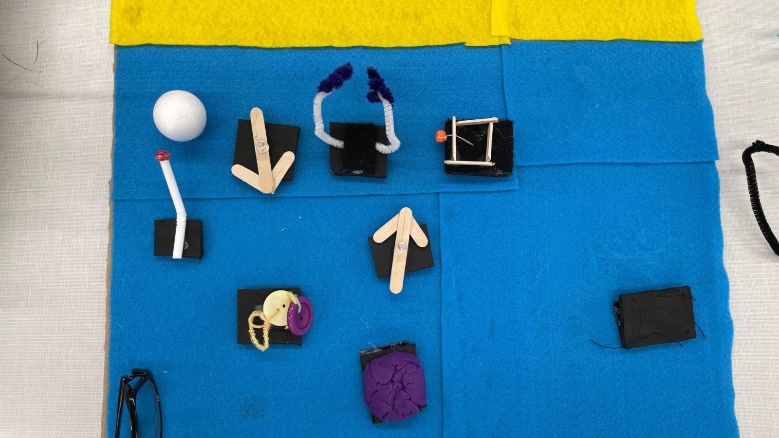 Communications Prototype made out of felt, popsycle sticks, and buttons