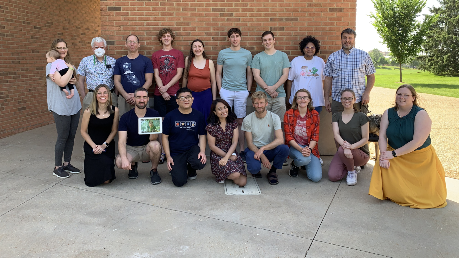 A group of attendees at the 2022 St. Louis retreat posed outside in front of a brick wall