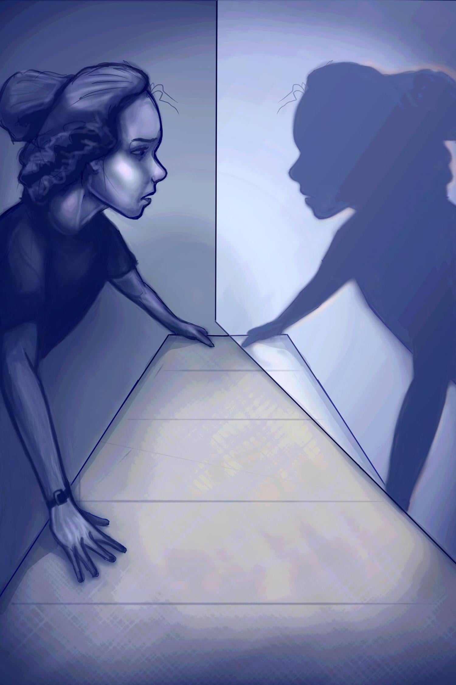 Girl looking in a mirror and her reflection is only a shadow.