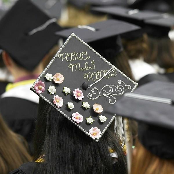 First mortarboard photo: Para mis papas. "For my parents."