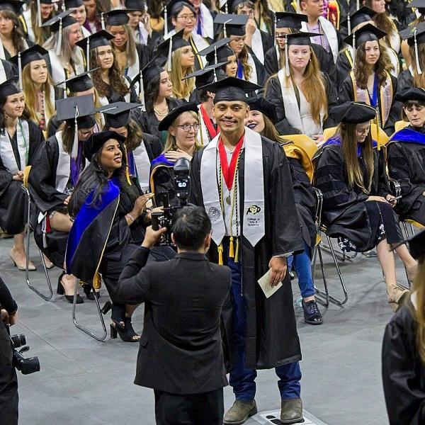 Before and after crossing the stage, graduates were photographed professionally by GradImages.